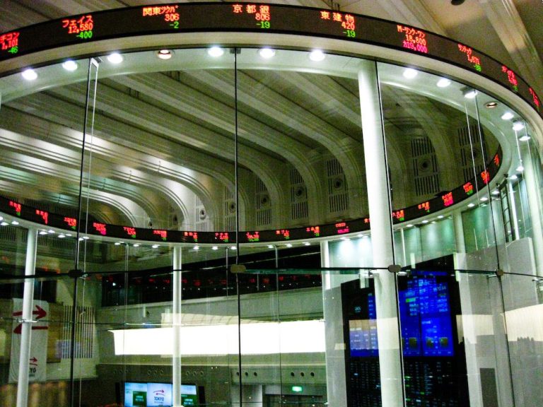 trader looking at multiple stock market screens